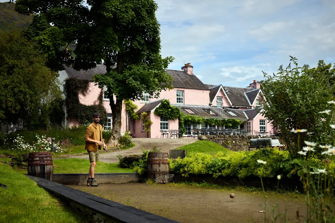 Exterior view of Monachyle Mhor boutique hotel in Balquhidder, surrounded by gardens.